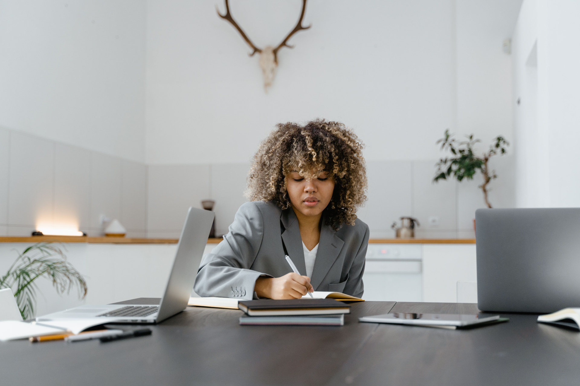 UK business owner reviewing plans at her desk